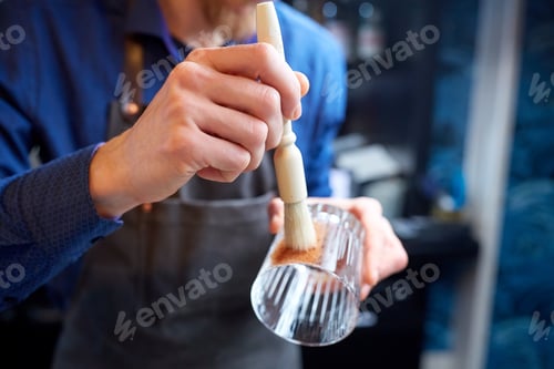 Preview: close up of bartender with glass and brush at bar