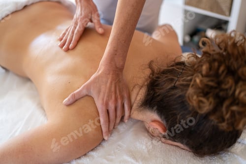 Preview: Crop masseuse kneading back of client in hospital room