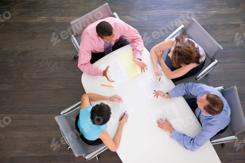 Preview: Four businesspeople at boardroom table