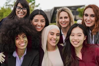 Preview: Smiling Women Working Together Outside in Sunlight