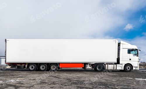 Preview: A big white truck with a white trailer standing on the countryside road in against a blue sky