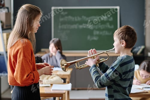 Preview: Boy Playing Trumpet At Music Lesson