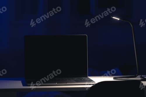 Preview: Black laptop screen in a dark room at night.