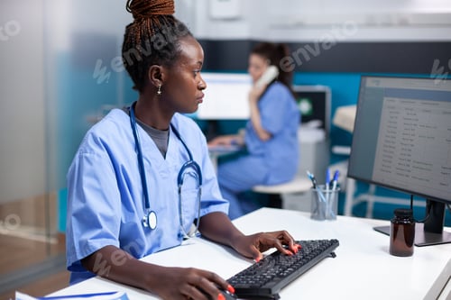 Preview: Nurse using computer at clinic desk