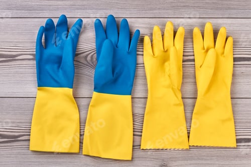 Preview: Rubber gloves on wooden background.