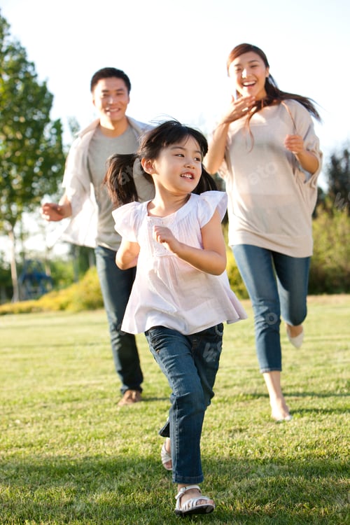 Preview: Young family running in a field