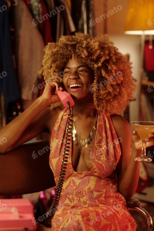 Preview: Smiling Woman Holding Wine Glass and Talking on Phone