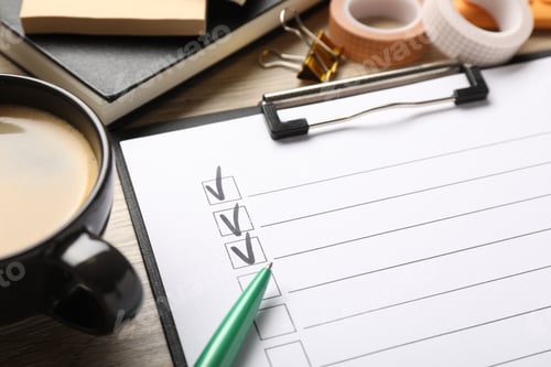 Preview: Checklist with marked checkboxes, stationery and coffee on wooden table, closeup