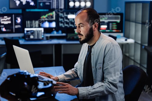 Preview: Business Trading Man sitting at desk at office working on laptop monitoring market exchange