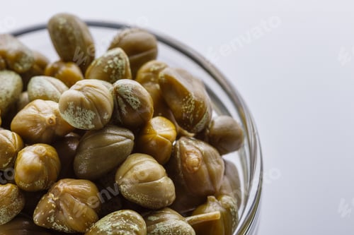 Preview: Pickled capers on a white acrylic background