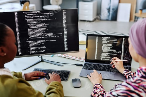 Preview: Two people writing code and reviewing project together
