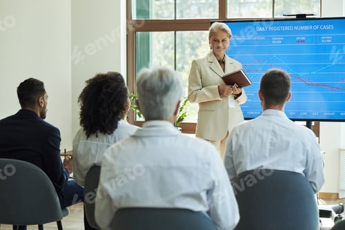 Preview: Senior Caucasian Woman Leading Medical Team Meeting Discussing Case Statistics