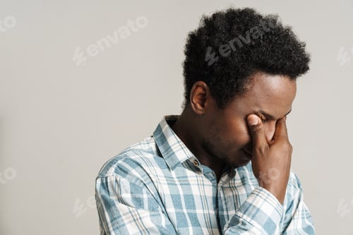 Preview: Black unshaven man in plaid shirt posing while covering her eyes