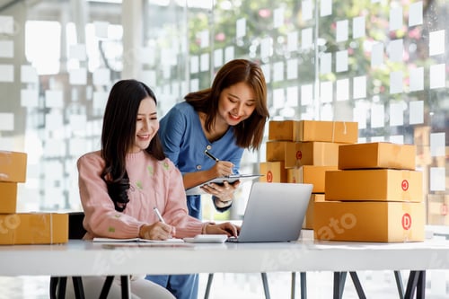 Preview: Two Young Asian women are happy and excited after a new order from SME customer, commercial checking
