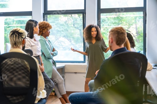 Preview: Woman leading a meeting with young people in a coworking
