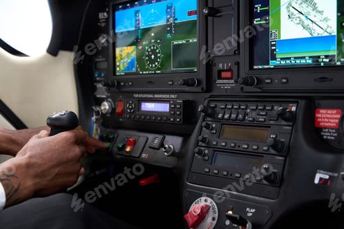 Preview: Pilot operating aircraft controls and avionics in cockpit during flight training