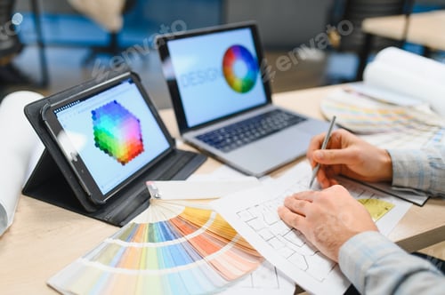 Preview: Interior designer drawing floor plan working on laptop