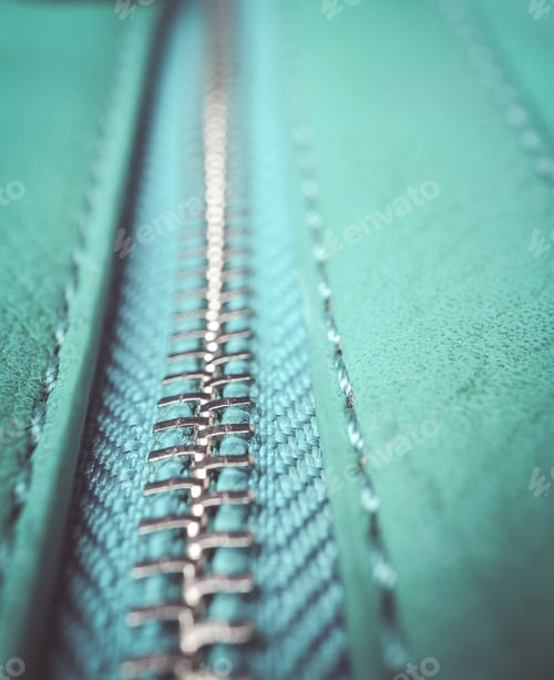 Preview: Closeup shot of a silver zipper on a blue leather fabric