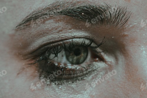 Preview: Eye of a female with black mascara and glow