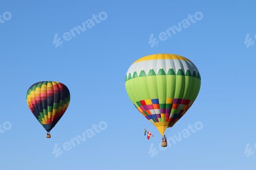 Preview: Colorful hot air balloons against blue sky.