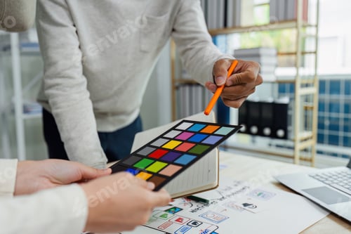 Preview: UI designer and UX developer brainstorm idea to design the application interface. Creative digital