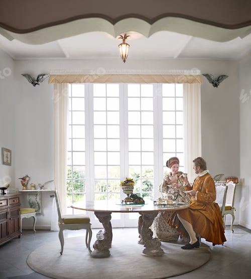 Preview: Tea and elegance. A king and queen taking tea together at home.