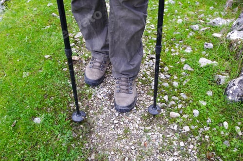 Preview: Woman hiking in mountains, adventure and exercising. Legs and nordic walking poles