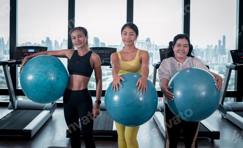 Preview: Sport fitness woman wearing sportwear with headband doing Pilates exercise her pelvis with fit ball
