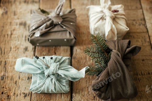 Preview: Stylish christmas gifts wrapped in fabric. Zero waste winter holidays.Furoshiki eco friendly present