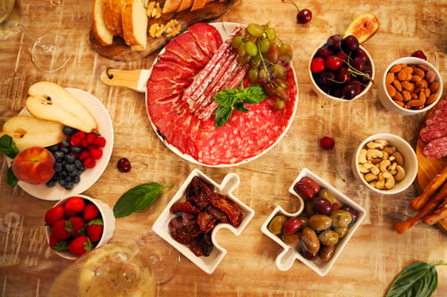 Preview: Dinner with snacks and wineglasses on table in living room