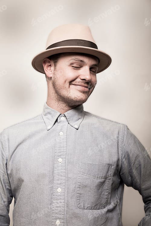Preview: Portrait of man wearing hat and grey shirt