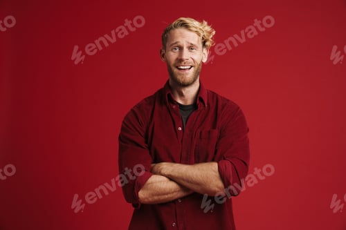 Preview: White bearded man looking at camera while posing with arms crossed