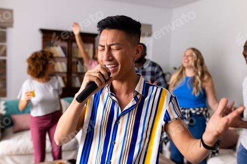 Preview: Happy diverse friends dancing and karaoke singing with microphone at home