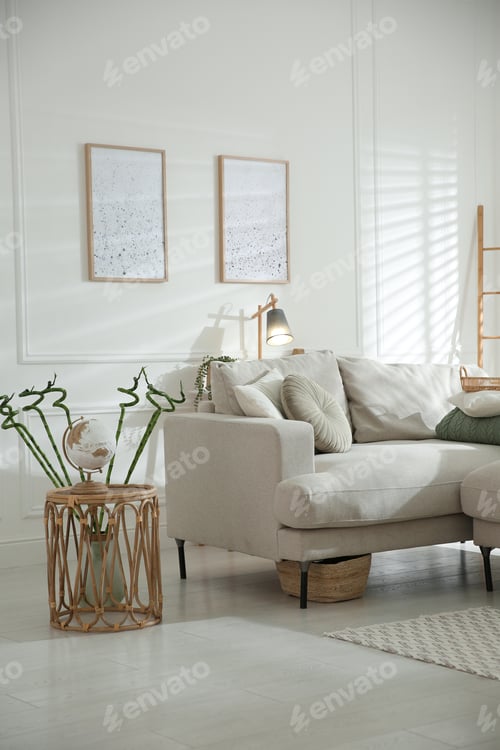 Preview: Stylish living room interior with comfortable grey sofa and beautiful pictures