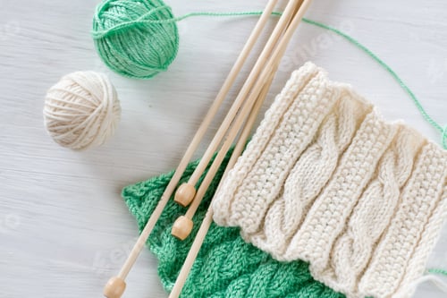 Preview: Two bright patterns, yarn balls and needles for knitting wooden white background