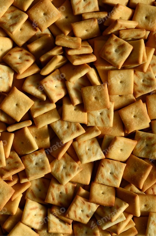 Preview: Background texture of small edible squares baked from dough and sprinkled with salt. A lot
