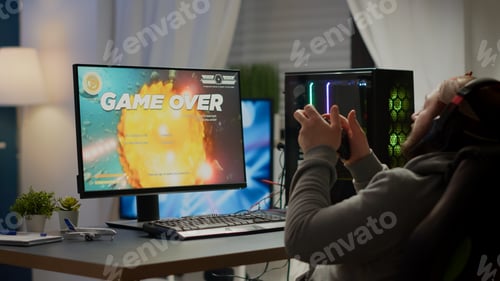 Preview: Focused pro cyber keeping hands on head after losing space shooter video game