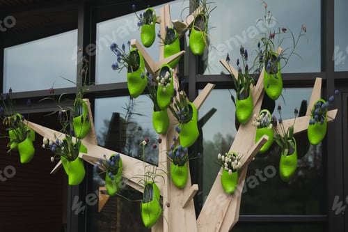 Preview: Green dutch wooden shoes with flowers inside on the wall