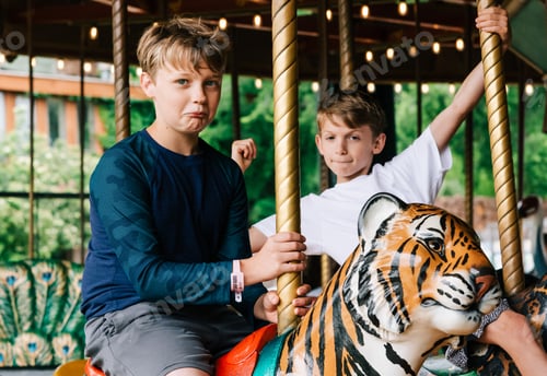 Preview: Two brothers ride on a carousel during a staycation!