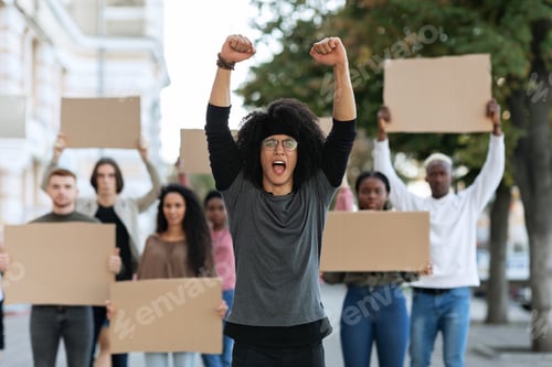 Preview: Motivated male leader standing over international group of protestors