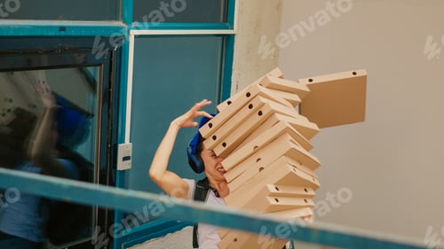 Preview: Female carrier trying to catch falling pizza boxes