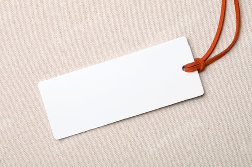 Preview: Cardboard tag with space for text on color fabric, top view