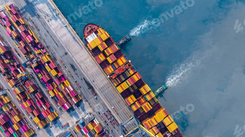 Preview: Aerial view container cargo ship at deep sea port terminal with tugboat assisting