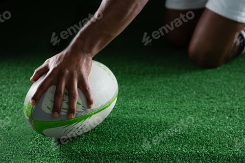 Preview: Close up of sportsman holding rugby ball