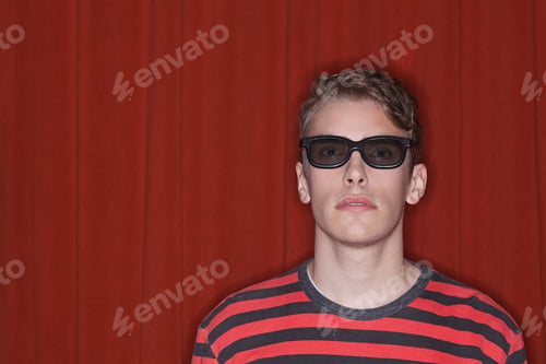 Preview: Portrait of young man against red background