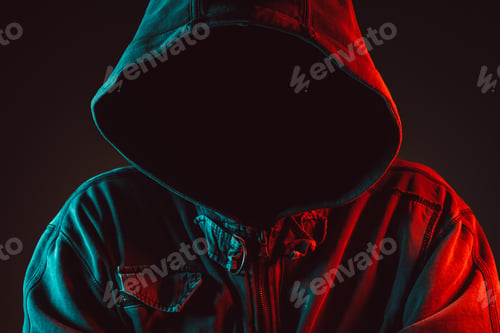 Preview: Red and blue lit low key portrait of hooded person