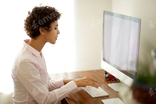 Preview: young woman working with computer in office