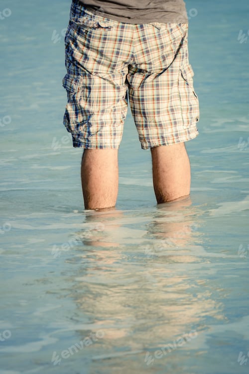 Preview: man standing in the sea water