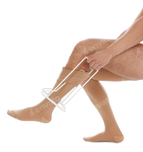 Preview: Man putting on compression garment with stocking donner against white background, closeup