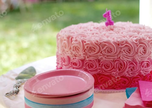 Preview: Pink first birthday cake of little girl on a table with matching plates and napkins